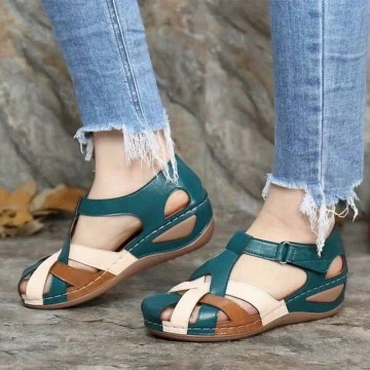 Teal casual sandals with white cross straps and cushioned platform sole
