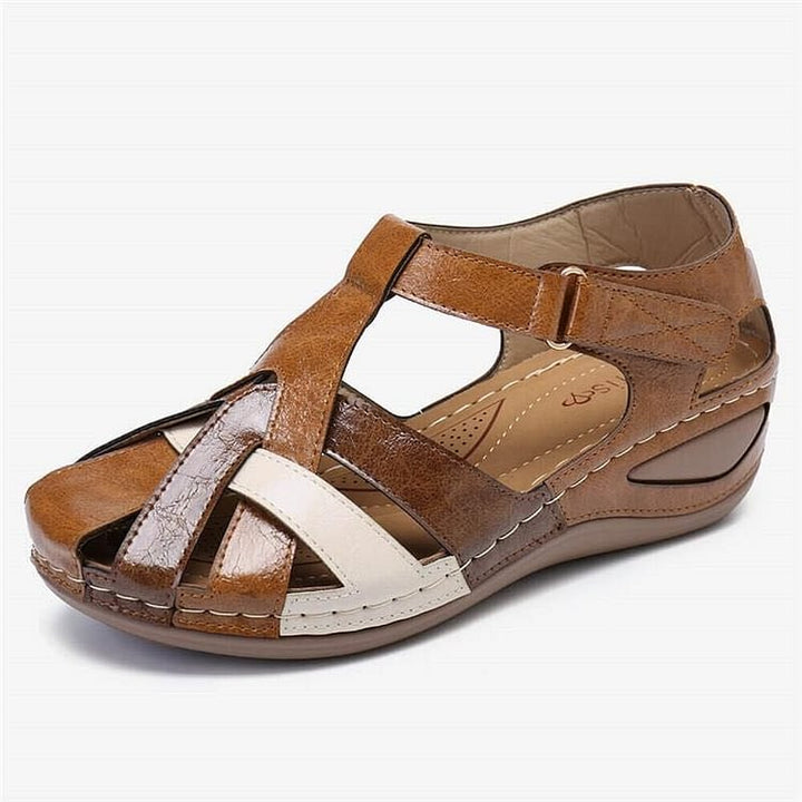 Tan brown casual sandals with white cross straps and cushioned sole