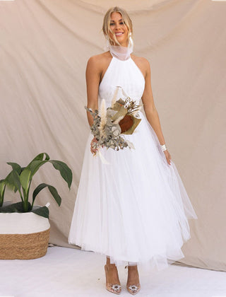 White halter turtleneck dress with layered tulle skirt and embellished bodice