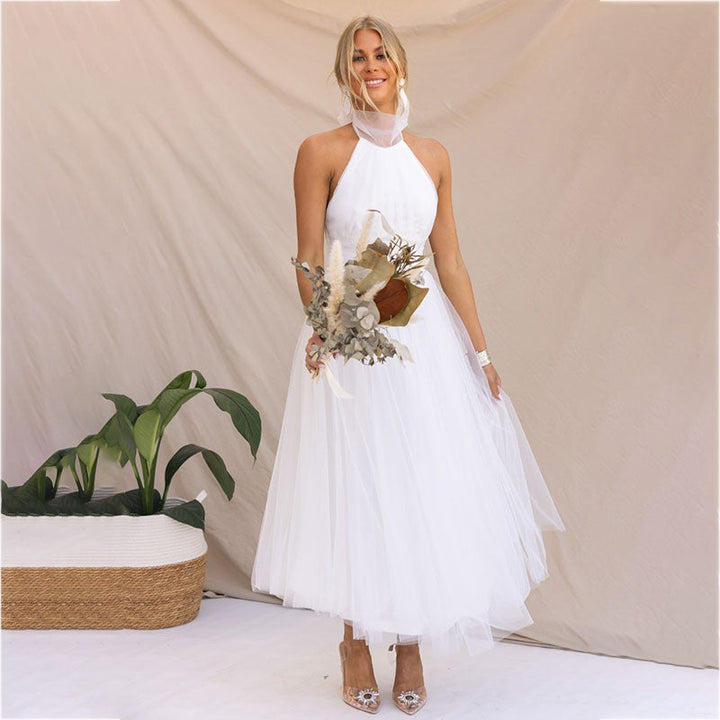 White halter turtleneck dress with layered tulle skirt and embellished bodice