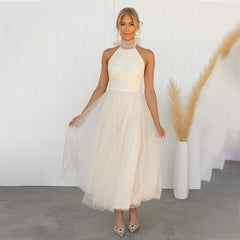 Ivory turtleneck tulle dress with halter neckline and full gathered skirt