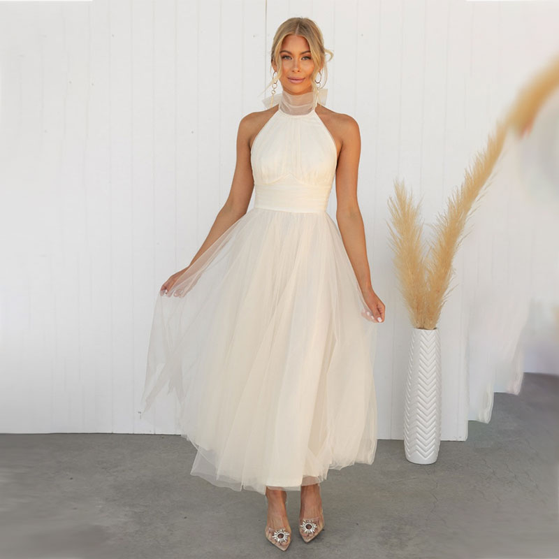 Ivory turtleneck tulle dress with halter neckline and full gathered skirt