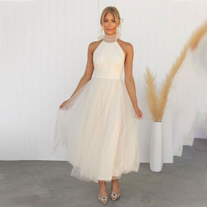 Ivory turtleneck tulle dress with halter neckline and full gathered skirt