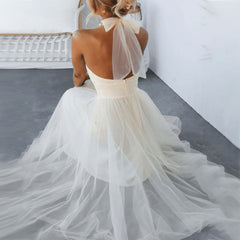 White turtleneck tulle dress with open back and sheer bow tie details