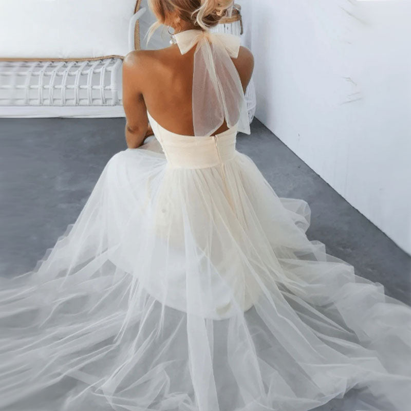 White turtleneck tulle dress with open back and sheer bow tie details