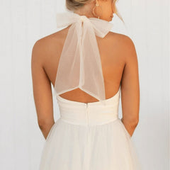 White sleeveless tulle dress with halter neck and open back panel