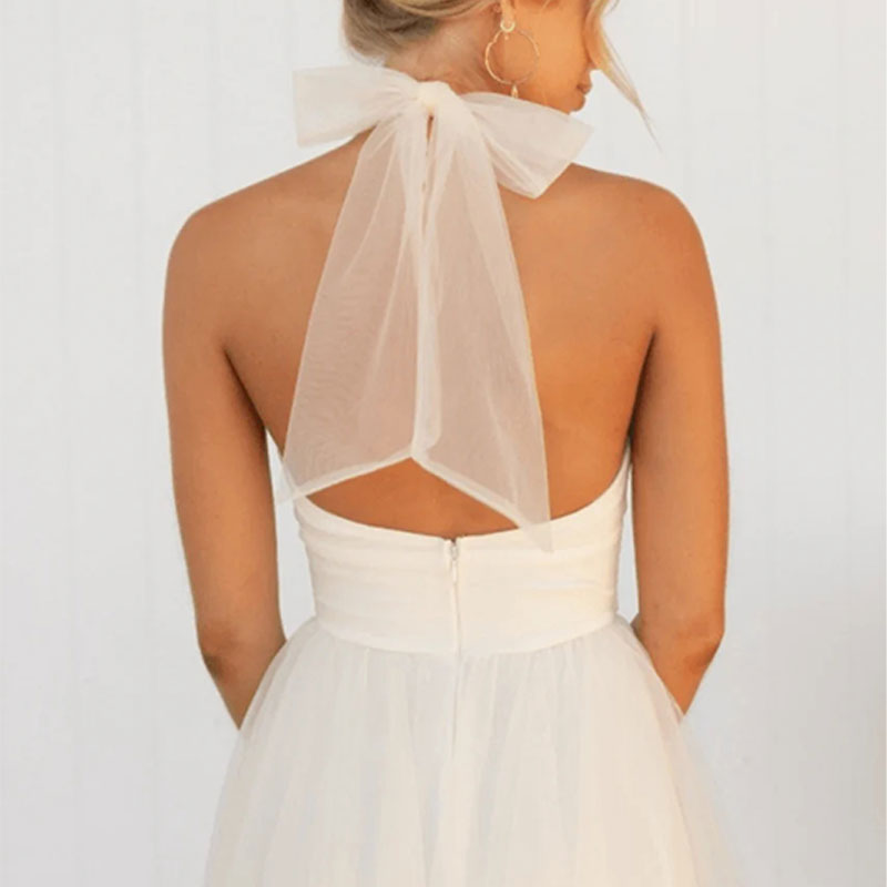 White sleeveless tulle dress with halter neck and open back panel