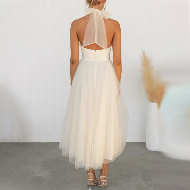 White tulle midi dress with high neckline, open-back strap, and bow