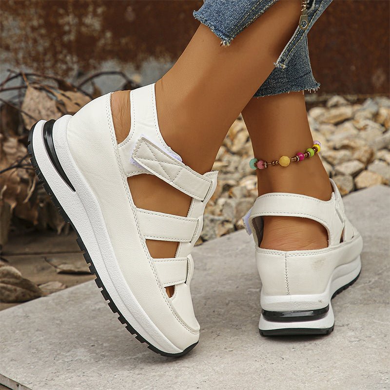 White closed-toe sneaker sandals, side view with cutout panels and hook-and-loop strap