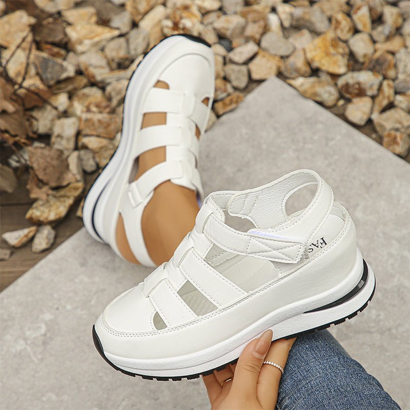 White closed-toe sneaker sandals with hook-and-loop straps and textured rubber sole