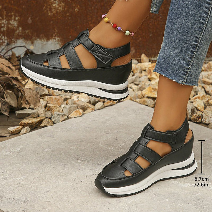 Black closed-toe sneaker sandals, side view with adjustable straps and white midsole