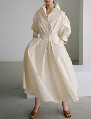Cream shirt dress with V-neck, button front, long sleeves, and tied waist