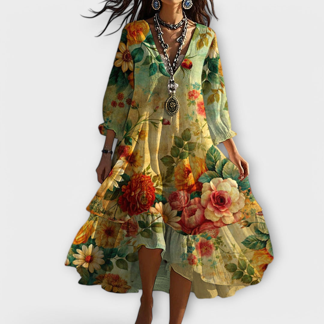 Yellow floral tiered dress with long sleeves, V-neck and flowing asymmetrical hem