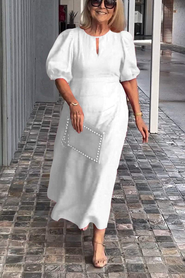 White puff-sleeve midi dress with keyhole neckline and subtle front seam detail
