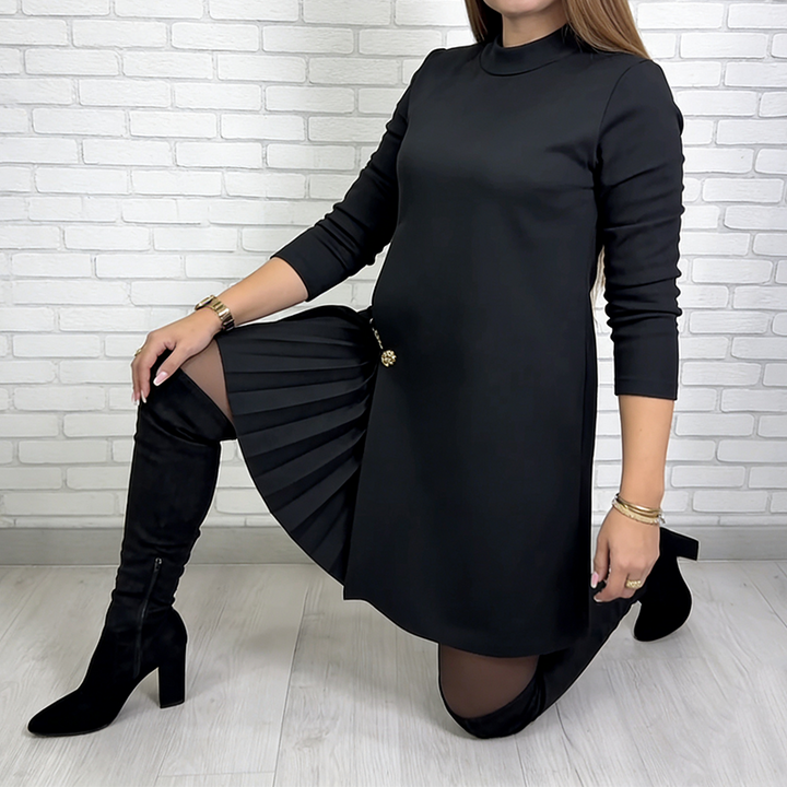 Black turtleneck pleated dress with gold button accent and draped pleat detail