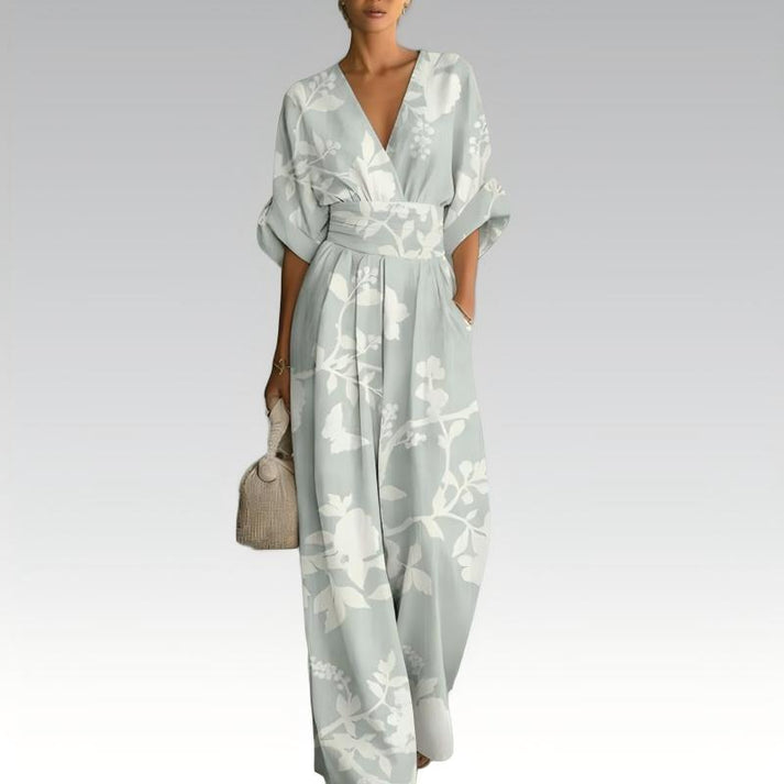 Light blue floral jumpsuit with V-neck, gathered waist, and flowy wide legs