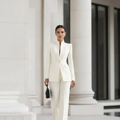 White blazer and wide-leg palazzo pants set, fitted jacket with long sleeves.