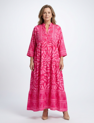 Pink button-front midi dress with V-neck and three-quarter sleeves, patterned print.