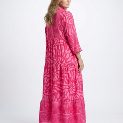 Pink button-front midi dress with V-neck and three-quarter sleeves, side view, patterned.