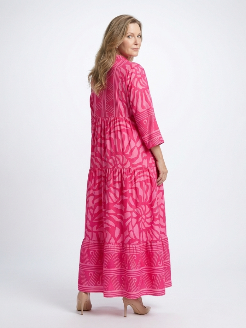 Pink button-front midi dress with V-neck and three-quarter sleeves, side view, patterned.