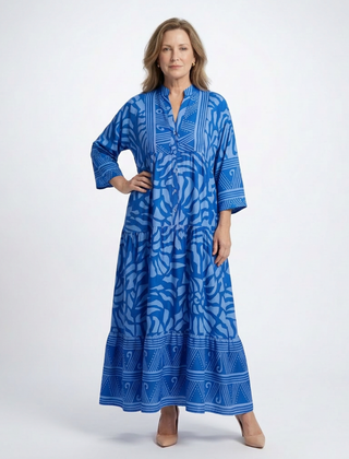 Blue button-front midi dress with V-neck and three-quarter sleeves, patterned print.