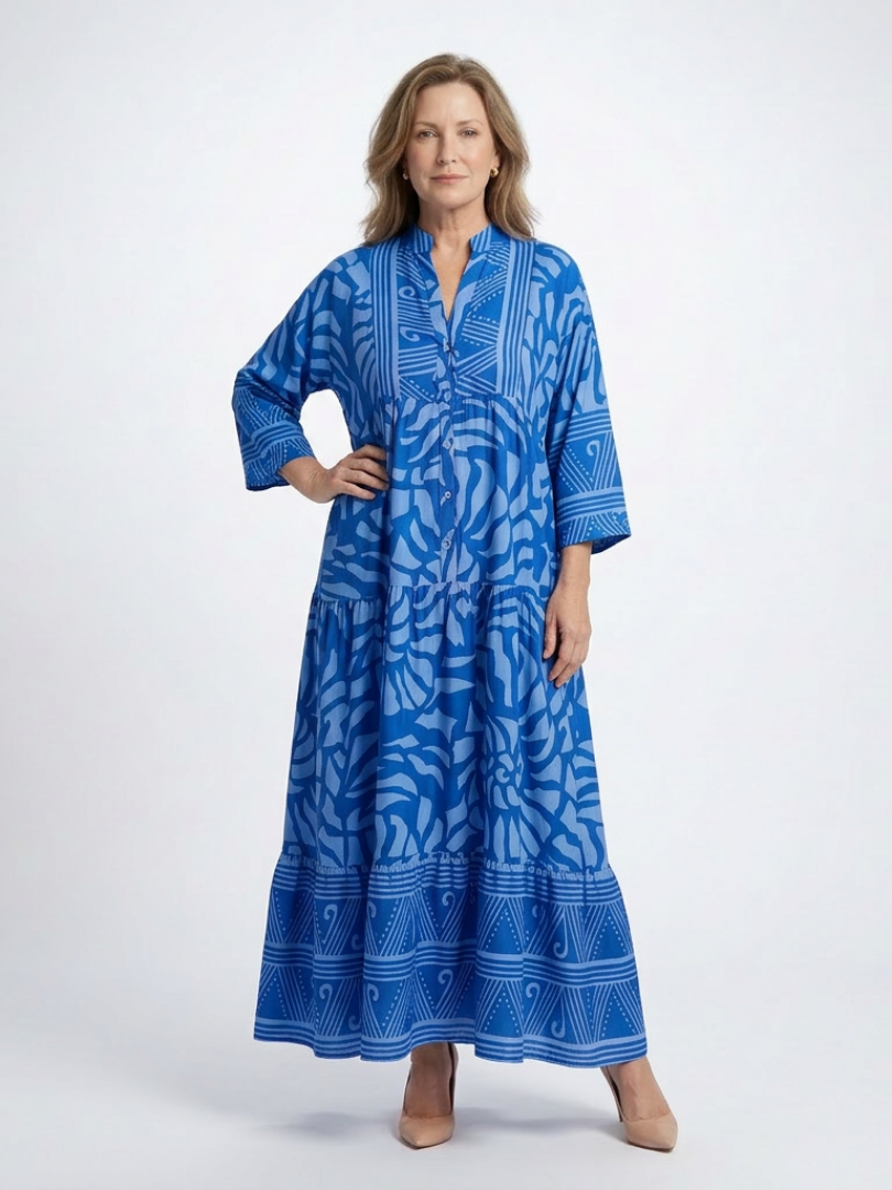Blue button-front midi dress with V-neck and three-quarter sleeves, patterned print.