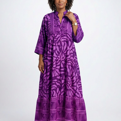 Purple button-front midi dress with V-neck and three-quarter sleeves, bold patterned print.