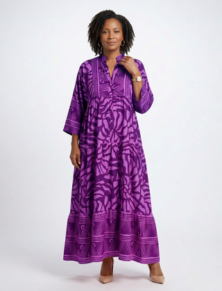 Purple button-front midi dress with V-neck and three-quarter sleeves, bold patterned print.
