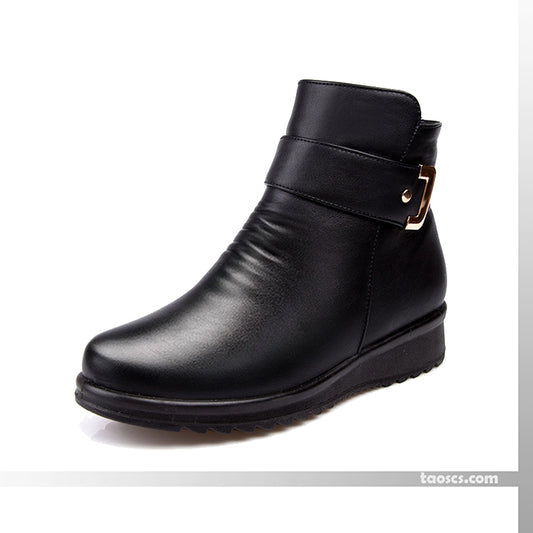 Black mid-top boots with side strap buckle and thick rubber sole