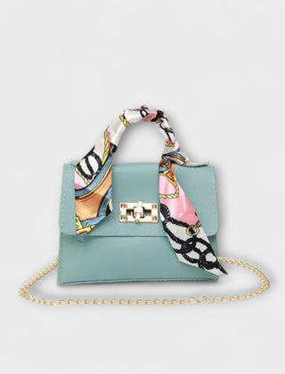 Light blue handbag with gold clasp, chain strap, and multicolor patterned scarf