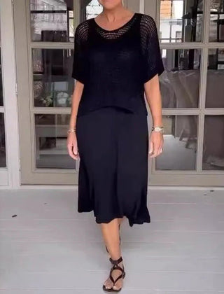 Black two-piece knit top and midi skirt set with short sleeves and a round neckline