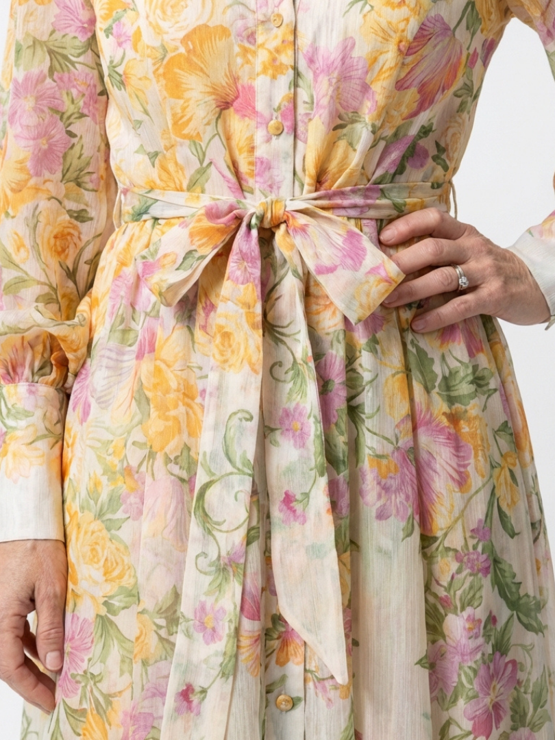 Floral sheer maxi dress close-up, tie waist bow and button placket detail