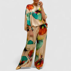 Two-piece set with loose top and wide-leg pants, cream background with green and orange florals