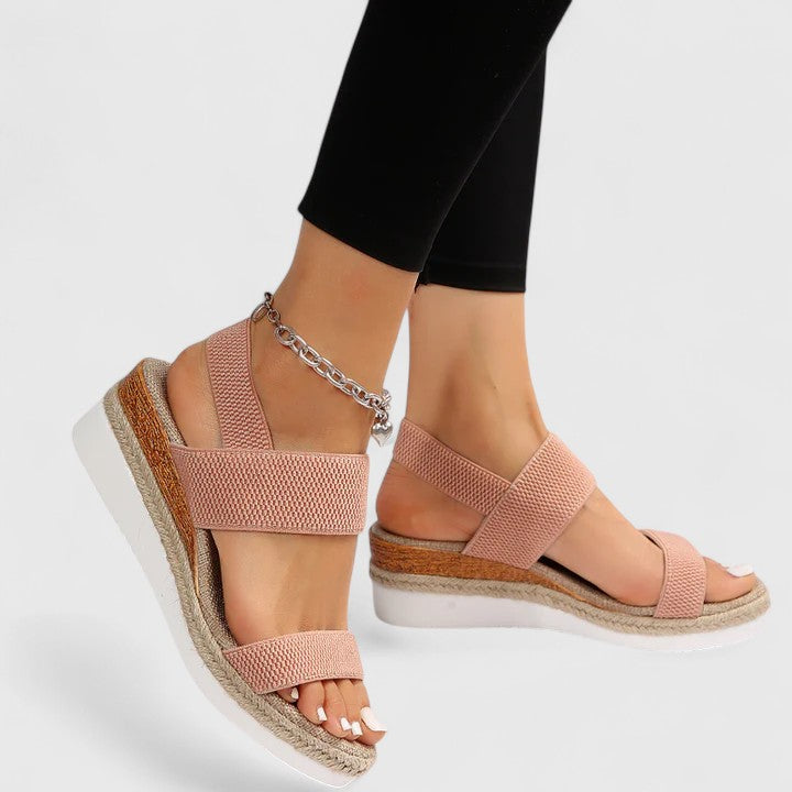 Orthopedic sandals in blush pink with wide straps and silver chain ankle bracelet