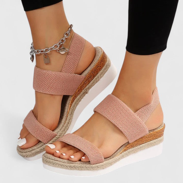 Orthopedic sandals in blush pink with wide straps and chain ankle bracelet with charm