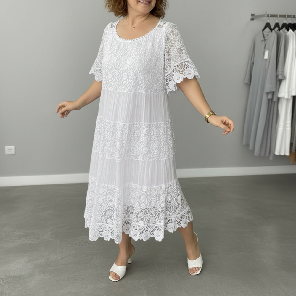 White lace midi dress with tiered skirt, short flutter sleeves, and round neckline