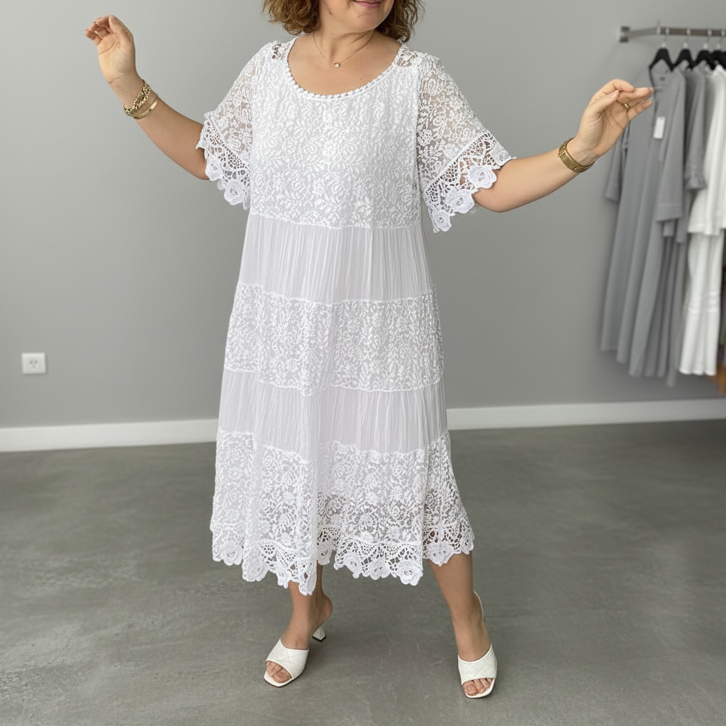 White tiered lace midi dress with scalloped sleeves and hem