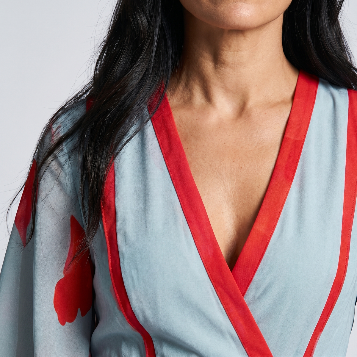 Light blue wrap dress neckline with red trim and V-neck detail, short sleeves