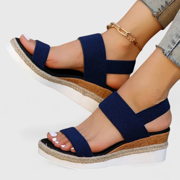 Orthopedic sandals in navy blue with wide crisscross straps and cork-look wedge sole