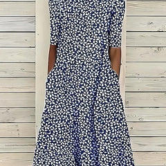 Navy and white patterned midi dress with short sleeves, fitted bodice, flared hem