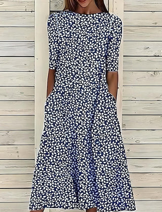 Navy and white patterned midi dress with short sleeves, fitted bodice, flared hem