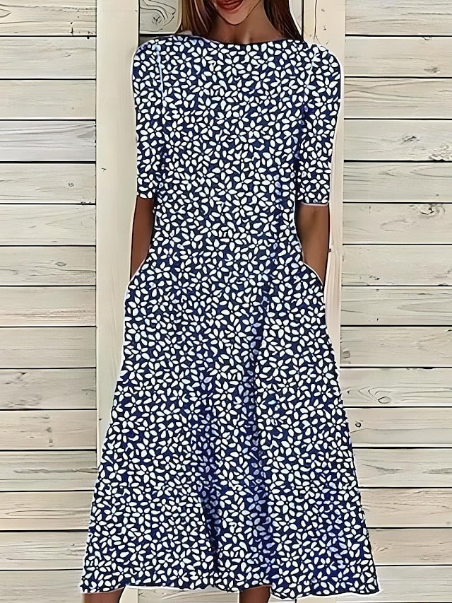 Navy and white patterned midi dress with short sleeves, fitted bodice, flared hem